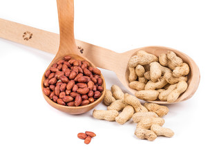 Wooden spoons full of peanuts.