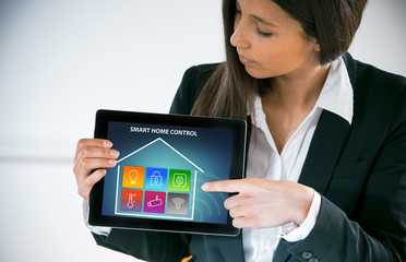Businesswoman pointing to a smart house interface