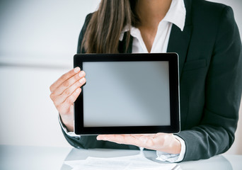 Fototapeta na wymiar Businesswoman displaying a blank tablet