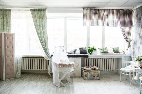 Interior in retro style bright room with a cot and large windows