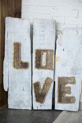 Inscription love on old wooden boards.