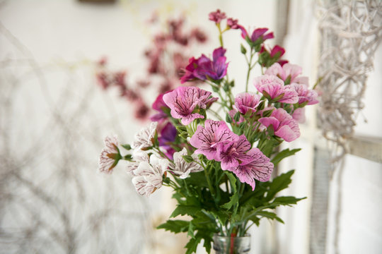 Bouquet of artificial flowers on a light background design