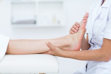 Obraz na płótnie Canvas Physiotherapist doing foot massage