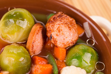 Fresh vegetable soup with sausage.