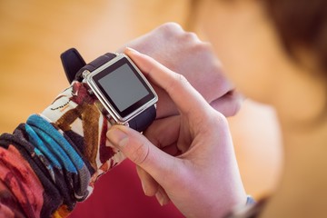 Slim woman using her smartwatch