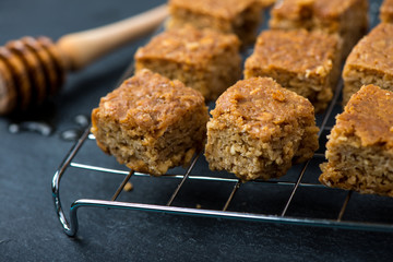 Homemade healthy flapjacks with honey on cooling rack