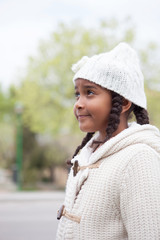 Pretty african girl with winter clothes outdoors