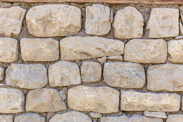 Wall of the house lined with stones