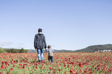 Mother and her little child having fun in a field