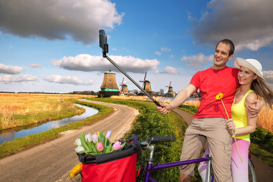 Couple taking Selfie against windmills near Amsterdam