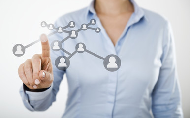 Businesswoman pressing people icon on digital touch screen