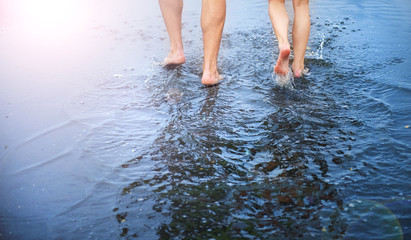 Fototapeta premium Unrecognizable woman and man in barefoot in a puddle