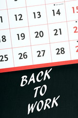 Back To Work reminder on a blackboard with calendar