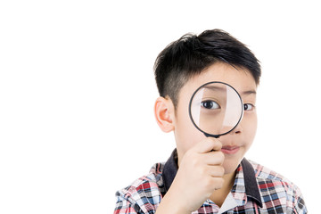 portrait of a young asian child looking through a magnifying gla