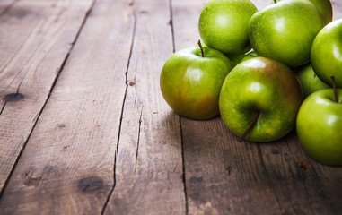 Ripe green apples on wooden background. fruits