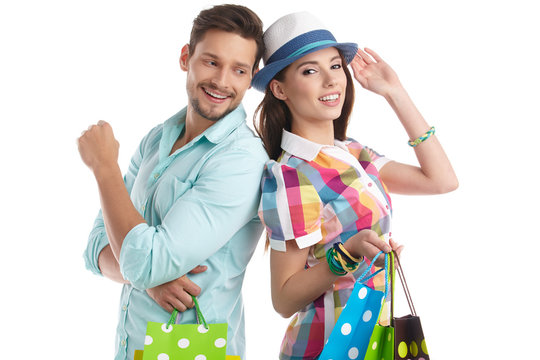 Attractive Young Couple With Shopping Bags On White Background