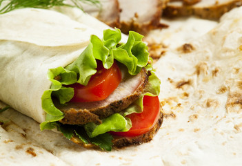 roll with meat and salad in pita bread