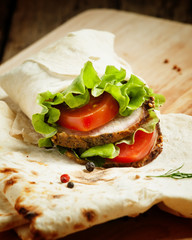 roll with meat and salad in pita bread