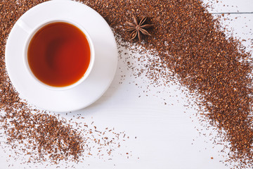 Top view of red traditional African rooibos tea in white cup