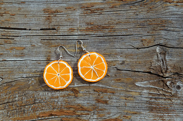 Pair of earrings from polymer clay on wooden background