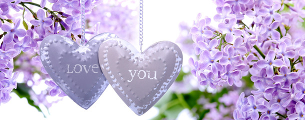 Lilac flowers  and metal hearts