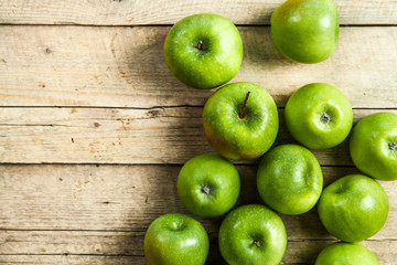 fruit. Ripe green apples on wooden background