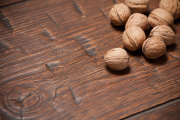 Walnuts on rustic old wooden table