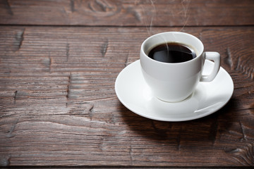 Coffee cup and saucer on wooden table