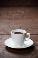 Coffee cup and saucer on wooden table
