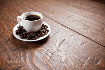 Coffee cup and saucer on wooden table
