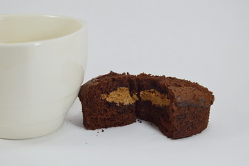 chocolate cake with cream filling and cup of coffee