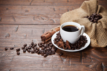 Cup of coffee with beans and spicery
