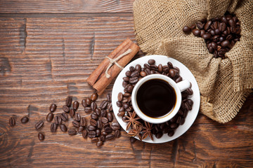 Cup of coffee with beans and spicery