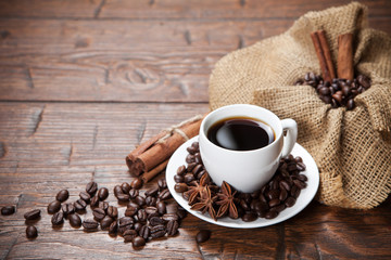 Cup of coffee with beans and spicery