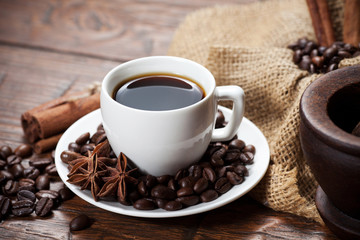 Cup of coffee with beans and spicery