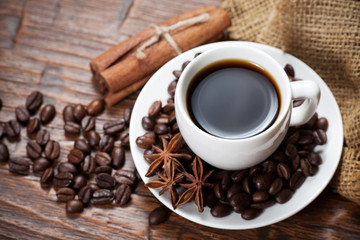 Cup of coffee with beans and spicery