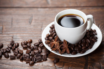Cup of coffee with beans and spicery