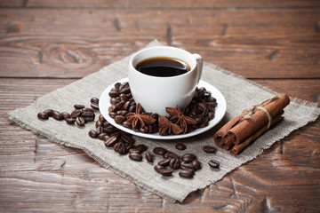 Cup of coffee with beans and spicery