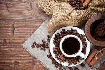 Cup of coffee with beans and spicery