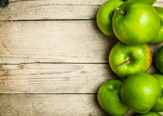 fruit. green apples on wooden background