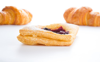 Delicious Cherry puff pastry with croissants isolated on white