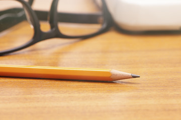 Yellow pencil on wooden table