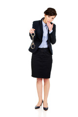 Businesswoman holding metal handcuffs.