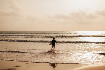 surfing man silhouette in waves