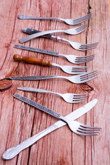 Array of rustic forks and a single knife