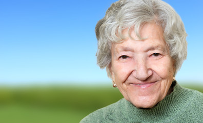 Happy senior lady portrait in nature