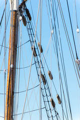 Obraz premium sailboat masts, rigging and rolled up sails