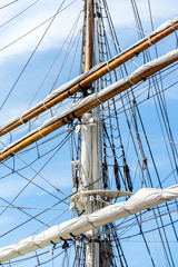 Obraz premium sailboat masts, rigging and rolled up sails