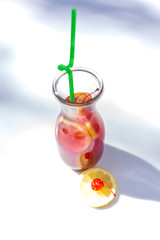 Lemonade in the jug with straws and lemons