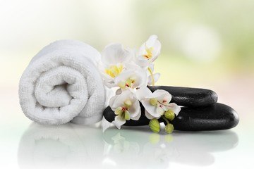 Spa Treatment. Towel, gladiola and pebbles for massage